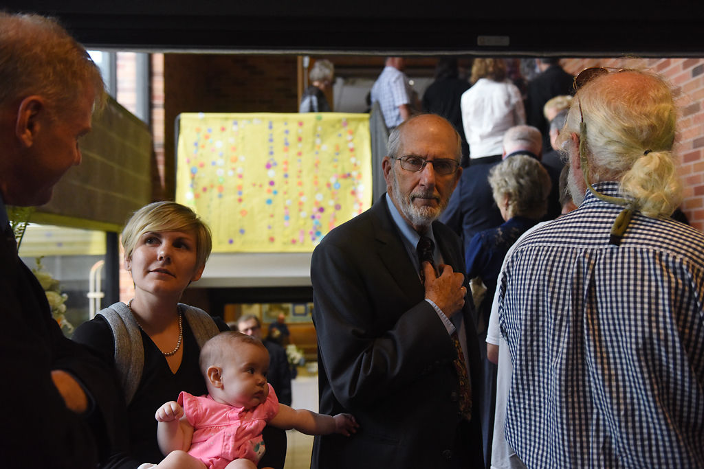 Brianna Lennon, her daughter Isabel Lennon Fines, and Jim Monin make their way toward the reception